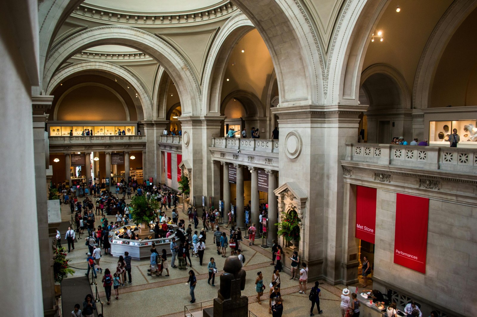 Visitors explore a historic museum with stunning vaulted ceilings and archways.